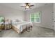 Inviting bedroom with neutral walls, decorative lighting, and white bedding at 2304 Thunder Gulch Ct, Waxhaw, NC 28173