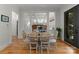 Inviting dining room with a round table, seating for six, hardwood floors, and open to other living spaces at 2304 Thunder Gulch Ct, Waxhaw, NC 28173