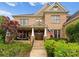 Charming two-story brick home featuring stone accents, a welcoming front porch, and professionally landscaped yard at 2304 Thunder Gulch Ct, Waxhaw, NC 28173