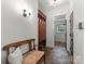 Hallway featuring a wooden storage cabinet, bench, tile flooring, and neutral walls at 2304 Thunder Gulch Ct, Waxhaw, NC 28173
