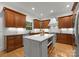 Open kitchen with a white marble island, custom cabinets, stainless appliances, and hardwood floors at 2304 Thunder Gulch Ct, Waxhaw, NC 28173