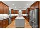 Spacious kitchen with stainless steel appliances, custom cabinets, a large center island and hardwood floors at 2304 Thunder Gulch Ct, Waxhaw, NC 28173