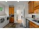 Functional laundry room with washer and dryer, cabinets, counter space, and tiled floor at 2304 Thunder Gulch Ct, Waxhaw, NC 28173