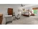 Spacious primary bedroom with a four-poster bed, sitting area, carpet floors, and lots of natural light at 2304 Thunder Gulch Ct, Waxhaw, NC 28173