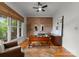 Well-lit office space with a large window, hardwood floors, stylish desk, and neutral décor at 2304 Thunder Gulch Ct, Waxhaw, NC 28173
