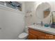 Charming powder room with wainscoting, wood vanity, stained glass, and decorative mirror at 2304 Thunder Gulch Ct, Waxhaw, NC 28173