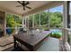 Screened porch featuring a ceiling fan, table, and views of the outdoor pool at 2304 Thunder Gulch Ct, Waxhaw, NC 28173