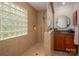 Bright bathroom featuring walk-in shower with glass block window, granite countertops, and wood cabinets at 2306 Beechwood Dr, Waxhaw, NC 28173