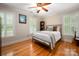 Cozy bedroom showcasing hardwood floors, ample natural light, and charming decor for a relaxing retreat at 2306 Beechwood Dr, Waxhaw, NC 28173