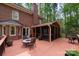 Outdoor deck featuring access to screened porch, fire pit and tree views at 2306 Beechwood Dr, Waxhaw, NC 28173
