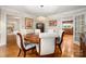Spacious dining room with hardwood floors, elegant light fixture, and doorways to other rooms in the home at 2306 Beechwood Dr, Waxhaw, NC 28173