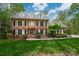 Traditional brick home with black shutters, dormer windows, and professionally landscaped front yard at 2306 Beechwood Dr, Waxhaw, NC 28173