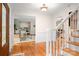Bright foyer featuring gleaming hardwood floors, white trim, and an open view into the adjacent living spaces at 2306 Beechwood Dr, Waxhaw, NC 28173