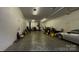 Spacious garage with Bendpak car lift, large windows, and plenty of room for storage at 2306 Beechwood Dr, Waxhaw, NC 28173
