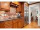Well-appointed kitchen with rich wood cabinetry, granite countertops, stainless steel appliances, and tiled backsplash at 2306 Beechwood Dr, Waxhaw, NC 28173