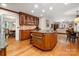 Open kitchen boasts granite counters, custom cabinets, hardwood floors, and modern appliances at 2306 Beechwood Dr, Waxhaw, NC 28173