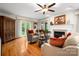 Cozy living room with hardwood floors, a fireplace, and access to the outdoor patio at 2306 Beechwood Dr, Waxhaw, NC 28173
