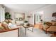 Elegant living room with hardwood floors, a comfortable sofa, a glass coffee table, and tasteful decor at 2306 Beechwood Dr, Waxhaw, NC 28173
