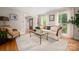 Bright living room with hardwood floors, a comfortable sofa, and windows that let in plenty of natural light at 2306 Beechwood Dr, Waxhaw, NC 28173