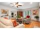 Inviting living room with hardwood floors, a ceiling fan, and ample natural light at 2306 Beechwood Dr, Waxhaw, NC 28173