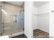 Modern bathroom featuring tiled shower, glass door, adjacent to a walk-in closet with wire shelving at 2311 Bulwarks Ct # 3P, Albemarle, NC 28001