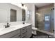 Bathroom featuring a double sink vanity, modern fixtures, and a glass-enclosed shower with tile surround at 2311 Bulwarks Ct # 3P, Albemarle, NC 28001