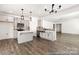 This spacious kitchen features gray cabinets, stainless steel appliances, quartz countertops and hardwood floors at 2311 Bulwarks Ct # 3P, Albemarle, NC 28001
