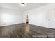 Open living space with neutral tones and views into an adjacent bathroom, featuring hardwood floors at 2311 Bulwarks Ct # 3P, Albemarle, NC 28001