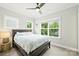 Well-lit bedroom with neutral walls, a dark wood bed, and big windows at 2541 Kenmore Ave, Charlotte, NC 28204