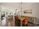 Dining room with hardwood floors, a rustic table, and seamlessly connected to the kitchen, creating an inviting atmosphere at 2541 Kenmore Ave, Charlotte, NC 28204