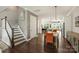Entryway with wooden stairs leading to the upper level, hardwood floors, and a seamless flow to the kitchen at 2541 Kenmore Ave, Charlotte, NC 28204