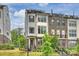 Beautiful townhome with a mix of gray siding and brick, a rooftop terrace, manicured landscaping, and inviting curb appeal at 2541 Kenmore Ave, Charlotte, NC 28204