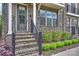 Inviting front entrance with brick steps, black railing, and meticulously maintained landscaping leading to the front door at 2541 Kenmore Ave, Charlotte, NC 28204