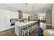 Modern kitchen with stainless steel appliances, a large center island with stools, and a seamless flow to the dining area at 2541 Kenmore Ave, Charlotte, NC 28204