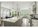 Bright kitchen with a large island, stainless steel appliances, hardwood floors, and many windows for natural light at 2541 Kenmore Ave, Charlotte, NC 28204