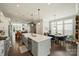 Spacious kitchen featuring a large island, stainless steel appliances, and hardwood floors extending to dining area at 2541 Kenmore Ave, Charlotte, NC 28204