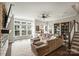 Spacious living room with large windows, a cozy sectional sofa, and built-in bookshelves at 2541 Kenmore Ave, Charlotte, NC 28204