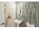 Stylish powder room with unique tiled accent wall, pedestal sink, and modern lighting at 2541 Kenmore Ave, Charlotte, NC 28204