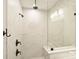 Modern shower with a glass enclosure, dark fixtures, and light tile walls at 2541 Kenmore Ave, Charlotte, NC 28204