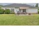 Backyard with grass, white siding home, patio furniture and grill at 2603 Willis Dr, Harrisburg, NC 28075
