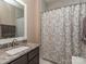 Bathroom featuring granite countertops, a framed mirror, and neutral shower curtain at 2603 Willis Dr, Harrisburg, NC 28075