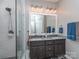 Renovated bathroom with a double vanity, stylish mirrors, modern fixtures, and a glass-enclosed shower at 2603 Willis Dr, Harrisburg, NC 28075