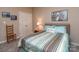 A cozy bedroom featuring striped bedding, a comfortable bed, and double door closet at 2603 Willis Dr, Harrisburg, NC 28075