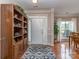 Welcoming foyer with hardwood floors, decorative rug, and a built-in bookcase at 2603 Willis Dr, Harrisburg, NC 28075