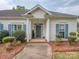 Inviting front entrance featuring a gray front door, white trim, and manicured landscaping at 2603 Willis Dr, Harrisburg, NC 28075