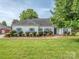 Charming one-story home with blue shutters, manicured landscaping, and a well-maintained lawn at 2603 Willis Dr, Harrisburg, NC 28075
