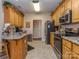 Functional kitchen with stainless steel appliances, wood cabinets, granite countertops, and ample storage space at 2603 Willis Dr, Harrisburg, NC 28075