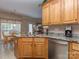 Well-equipped kitchen island with granite countertops, stainless steel appliances, and wood cabinetry at 2603 Willis Dr, Harrisburg, NC 28075