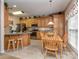 Inviting eat-in kitchen featuring wood cabinets, granite countertops, stainless steel appliances, and a sunny breakfast nook at 2603 Willis Dr, Harrisburg, NC 28075