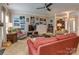 Spacious living room with cozy seating, a ceiling fan, and an array of colorful wall art at 2603 Willis Dr, Harrisburg, NC 28075